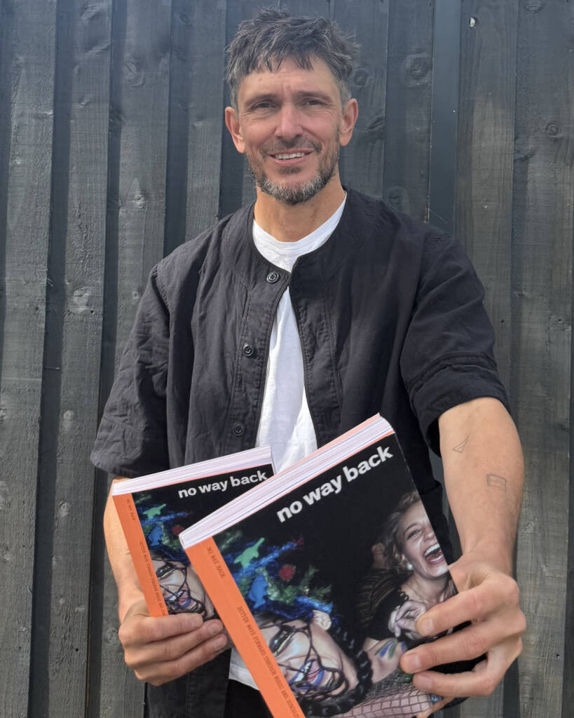 Andy Crysell holding copies of issue two of No Way Back magazine